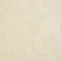 Cream-colored textured wallpaper featuring an embossed damask pattern. The Royalty Free Stock Photo