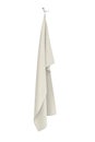 Cream colored towel hanging on a metal double handle on a white background