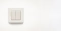 Cream colored wall mounted cream colored double light switch Royalty Free Stock Photo