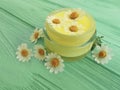 Cream cosmetic daisy chamomile freshness extract on a blue wooden background Royalty Free Stock Photo