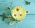 Cream cosmetic daisy chamomile freshness on a blue wooden background Royalty Free Stock Photo