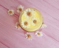 Cream cosmetic daisy extract freshness flower on a pink wooden background Royalty Free Stock Photo