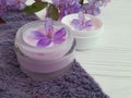 Cream cosmetic relaxation flowers wellness product handmade on blue wooden