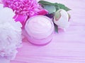 Cream cosmetic protection bloom peony cleanser moisturizing spring aromatherapy flower wooden background Royalty Free Stock Photo