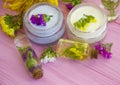 Cream cosmetic, wild flowers, moisturizer essence vintage on a wooden background Royalty Free Stock Photo