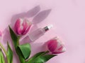 Cream cosmetics flower aroma product  composition    tulip on colored background Royalty Free Stock Photo