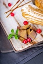 Cream eclairs choux pastries served with fresh cranberries on a handmade ceramic plate. Profiterole cupcakes Royalty Free Stock Photo