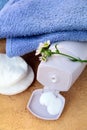 Cream for face and body in bank and towel