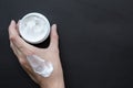 Cream for face or body in female hand. Smear cream on hand Royalty Free Stock Photo