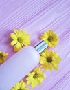 Facial glass cream cosmetic cleanser daisy yellow flowers pink wooden Royalty Free Stock Photo