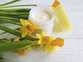 Cream facial skin cosmetic extract pot care narcissus ointment rustic organic daffodil on white wooden treatment