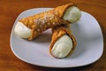 Cream filled cannolis arranged on a plate