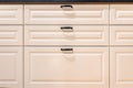 Cream kitchen drawers with black handles and clean lines. Soft minimal. Royalty Free Stock Photo