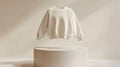 Cream Knit Sweater on Beige Pedestal Royalty Free Stock Photo