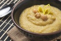 Cream of leek and chickpeas in a black round bowl