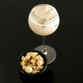 Cream liqueur with ice and bowl of mixed nuts. Conceptual image Royalty Free Stock Photo