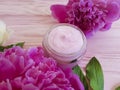 Cream moisturize cosmetic, peony flower rustic on a pink wooden background Royalty Free Stock Photo