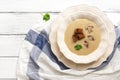 Cream of mushroom soup with croutons on a white wooden rustic table, top view. Hot winter soup Royalty Free Stock Photo