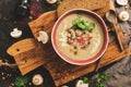 Cream of mushroom soup on a cutting board, rustic background. Winter warming hot soup. Top view, flat lay