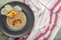 Cream of mushroom soup in dark bowl. Homemade creamy soupe with sliced boletus mushrooms.