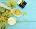 Cream product cosmetic skin extract care yellow ointment flowers on a wooden background