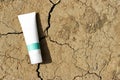 Cream product on dry cracked ground drought background, Cosmetic product branding mockup. Royalty Free Stock Photo