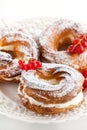 Cream puff rings decorated with fresh red currant Royalty Free Stock Photo