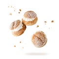 Cream puffs, pastry from choux covered sugar powder with crumbs falling flying isolated on white background Royalty Free Stock Photo