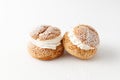 Cream puffs, pastry from choux covered sugar powder on white background Royalty Free Stock Photo