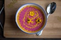 Cream pumpkin and beet soup with fresh yellow flowers