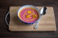 Cream pumpkin and beet soup with fresh yellow flowers