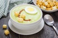 Cream soup with avocado, garnished with egg and croutons Royalty Free Stock Photo