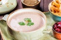 Cream soup with beans, vegetables, herbs and crackers on plate on dark wooden background. Homemade food. Royalty Free Stock Photo