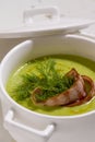 Cream soup with broccoli and grilled bacon flower .