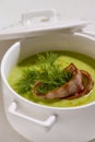 Cream soup with broccoli and grilled bacon flower .