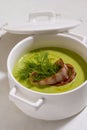 Cream soup with broccoli and grilled bacon flower .