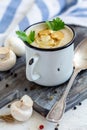 Cream-soup with champignons in an enamel mug Royalty Free Stock Photo