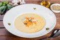 Cream soup with chicken breast, mushrooms, herbs on plate on dark wooden background. Royalty Free Stock Photo