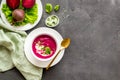 Cream soup made of red beet with raw beet roots Royalty Free Stock Photo