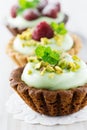 Cream tarts with nuts, raspberry and mint