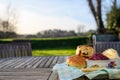 Cream tea, scones, jam and clotted cream set out on a garden table with a countryside view. Royalty Free Stock Photo