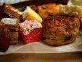 Cream tea with selection of cakes scones and sweets with strawberries Royalty Free Stock Photo