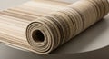 Rolled carpet with a striped pattern featuring various shades of beige, brown, and Royalty Free Stock Photo