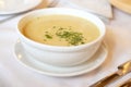 Cream wild mushroom soup in white bowl -selective focus