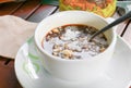 Creamer in cappuccino insoluble on the wooden floor background