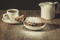 creamer, coffee cup with cinnamon and cookies/white creamer, coffee cup with cinnamon and cookies on a wooden table sprinkled Royalty Free Stock Photo