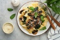 Creamy Alfredo pasta. Italian pasta fettuccini with mushrooms, chicken meat, spinach, basil and cream sauce on grey stone or concr Royalty Free Stock Photo