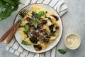 Creamy Alfredo pasta. Italian pasta fettuccini with mushrooms, chicken meat, spinach, basil and cream sauce on grey stone Royalty Free Stock Photo