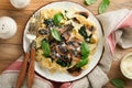 Creamy Alfredo pasta. Italian pasta fettuccini with mushrooms, chicken meat, spinach, basil and cream sauce on old rustic table Royalty Free Stock Photo