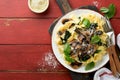 Creamy Alfredo pasta. Italian pasta fettuccini with mushrooms, chicken meat, spinach, basil and cream sauce on red old rustic tabl Royalty Free Stock Photo